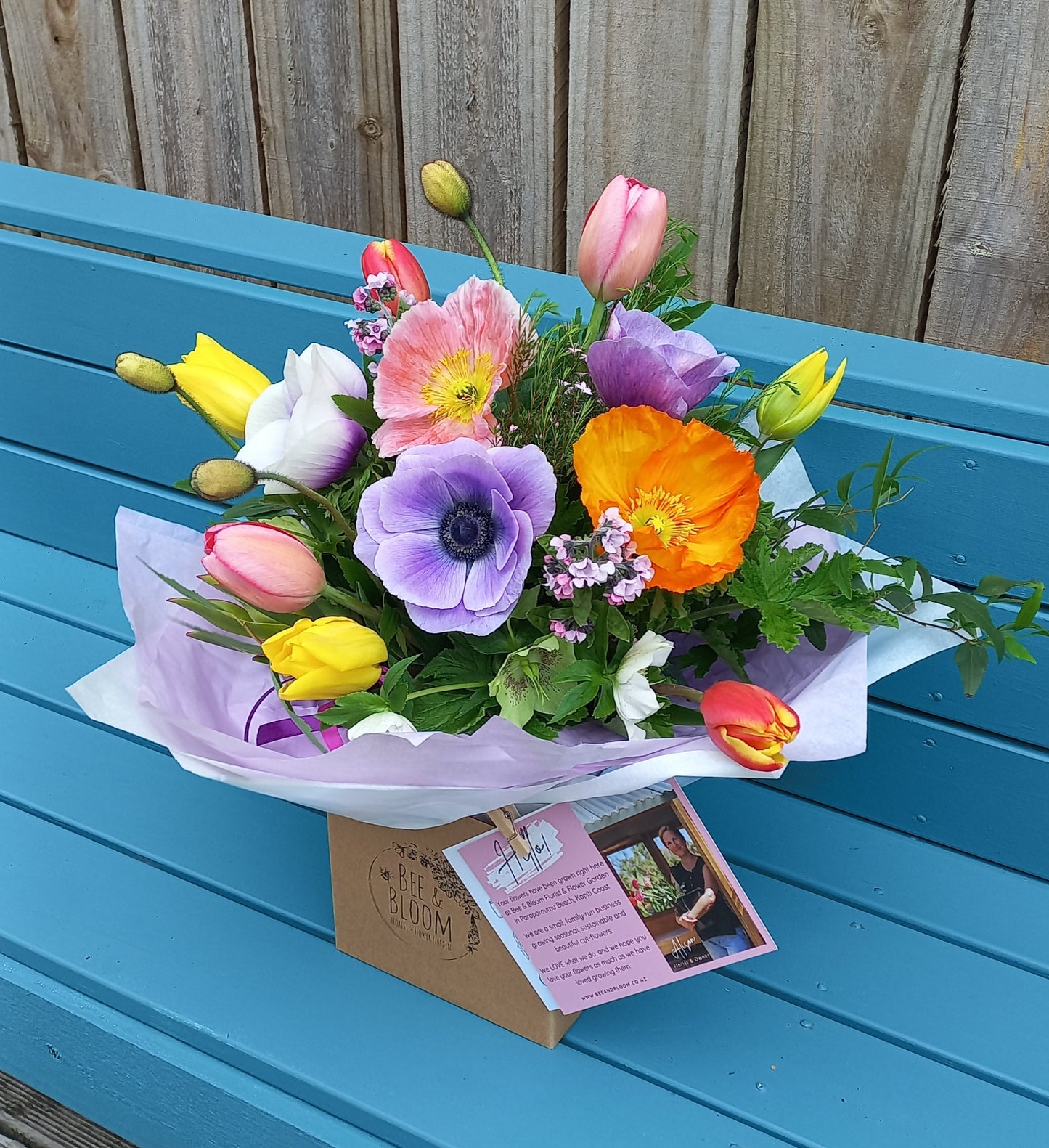 Colorful bouquet of flowers on a blue door