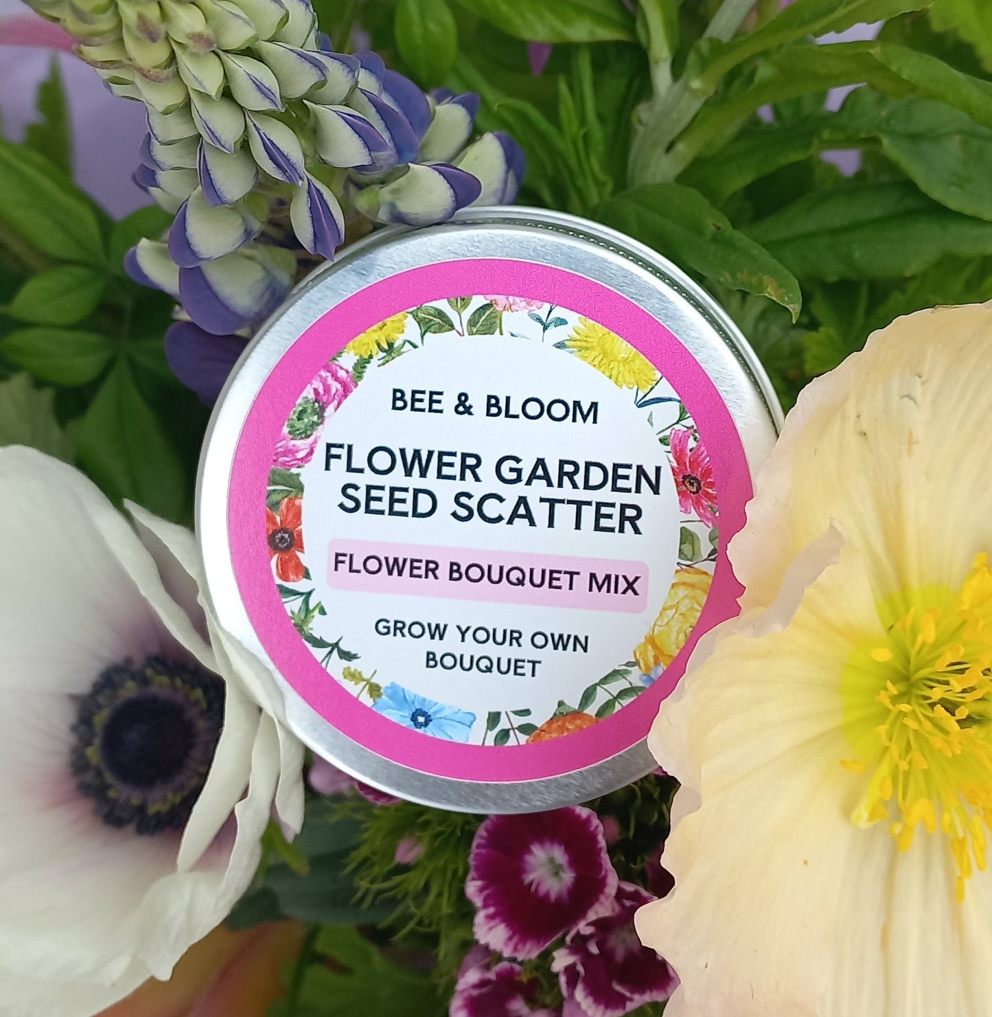 Bee & Bloom Flower Garden Seed Scatter tin surrounded by flowers