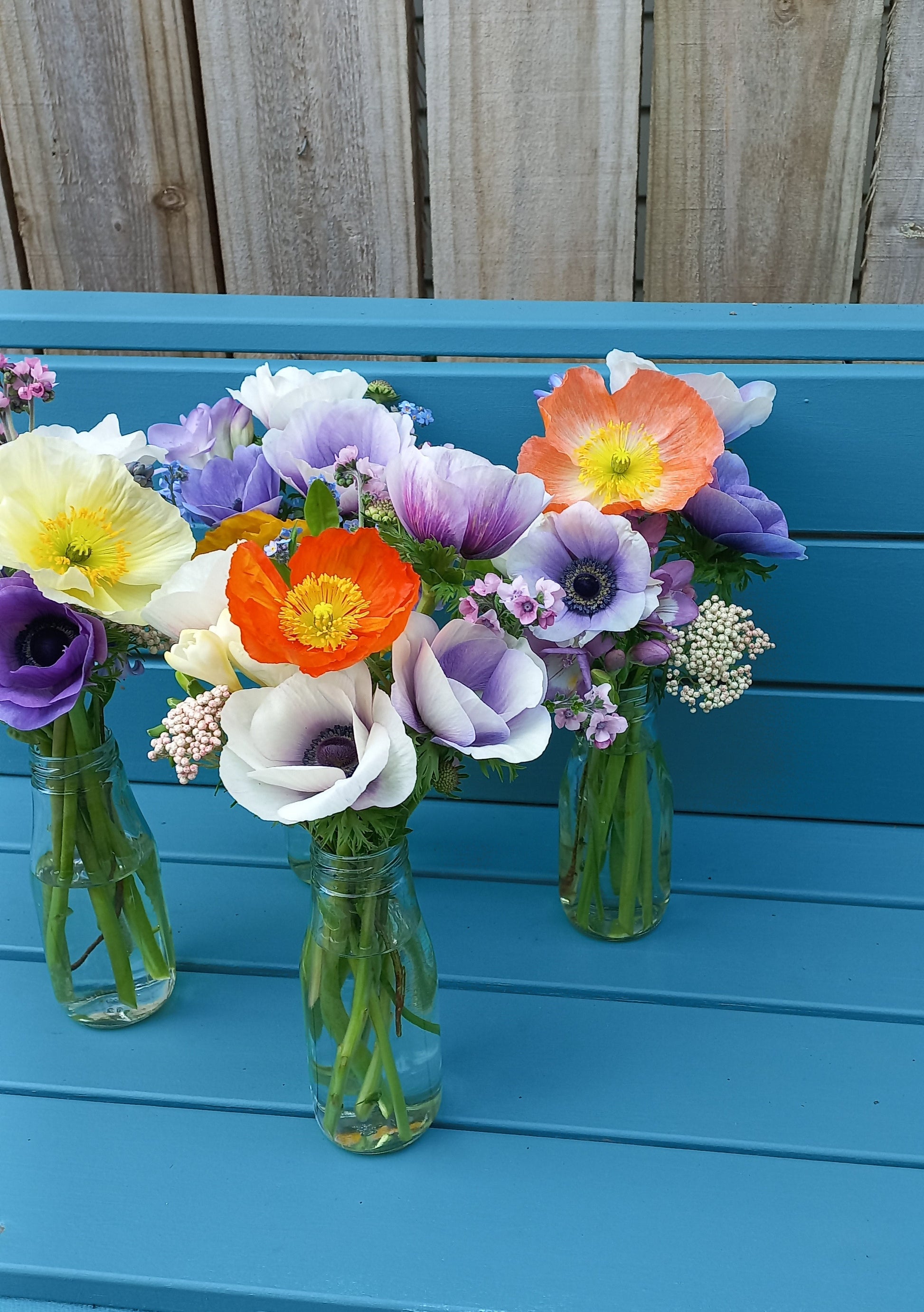 Colorful flower arrangement against a blue wooden background