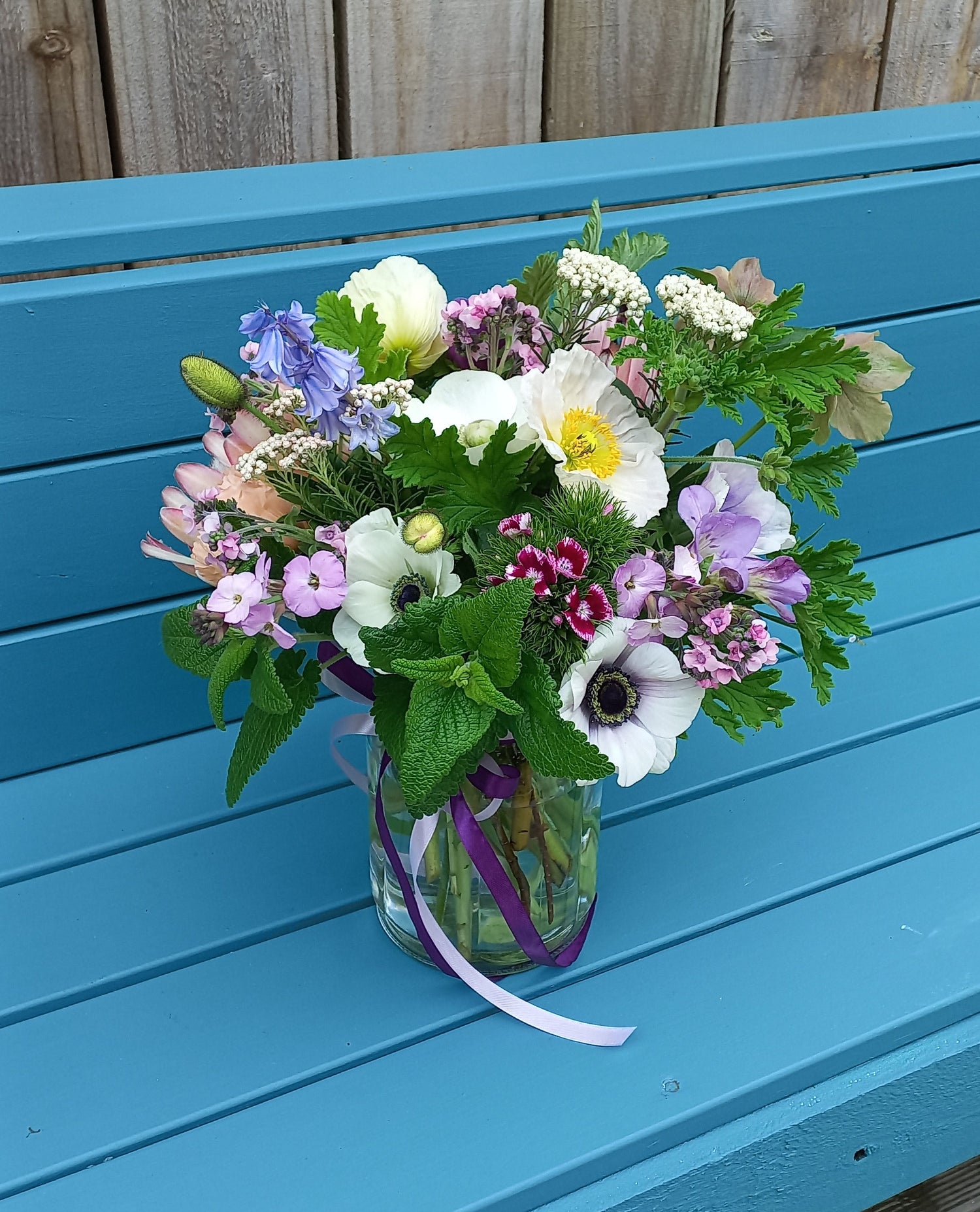 Bouquet of flowers on a blue wooden surface