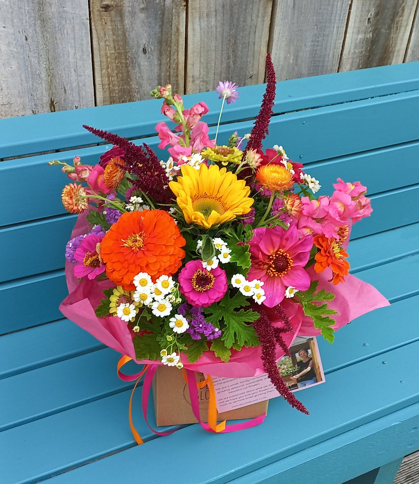 Colorful bouquet of flowers on a blue wooden surface