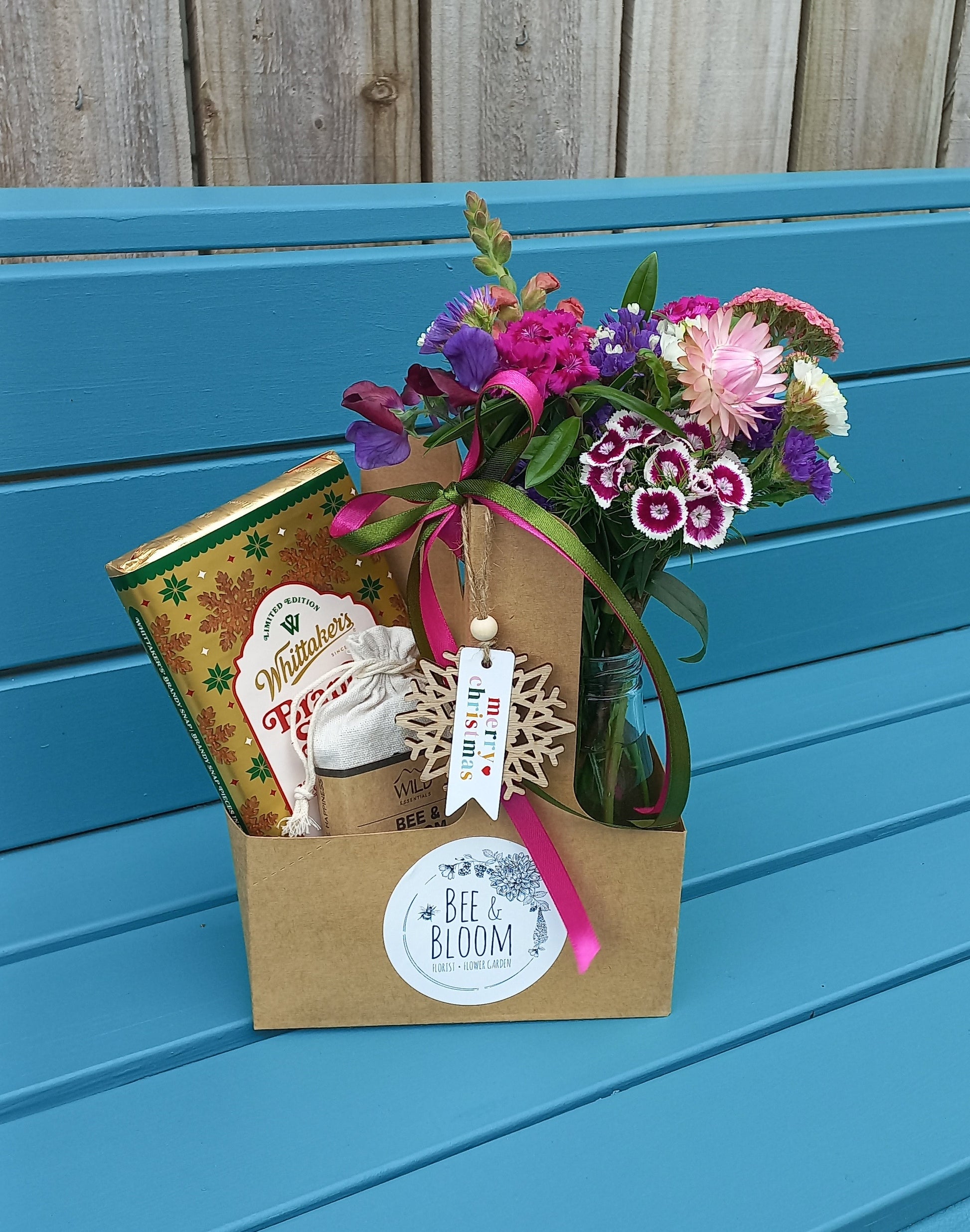 Gift box with flowers on a blue surface